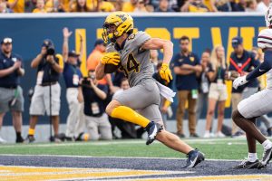 Clement helps WVU top Duquesne 56-17 following extended weather delay